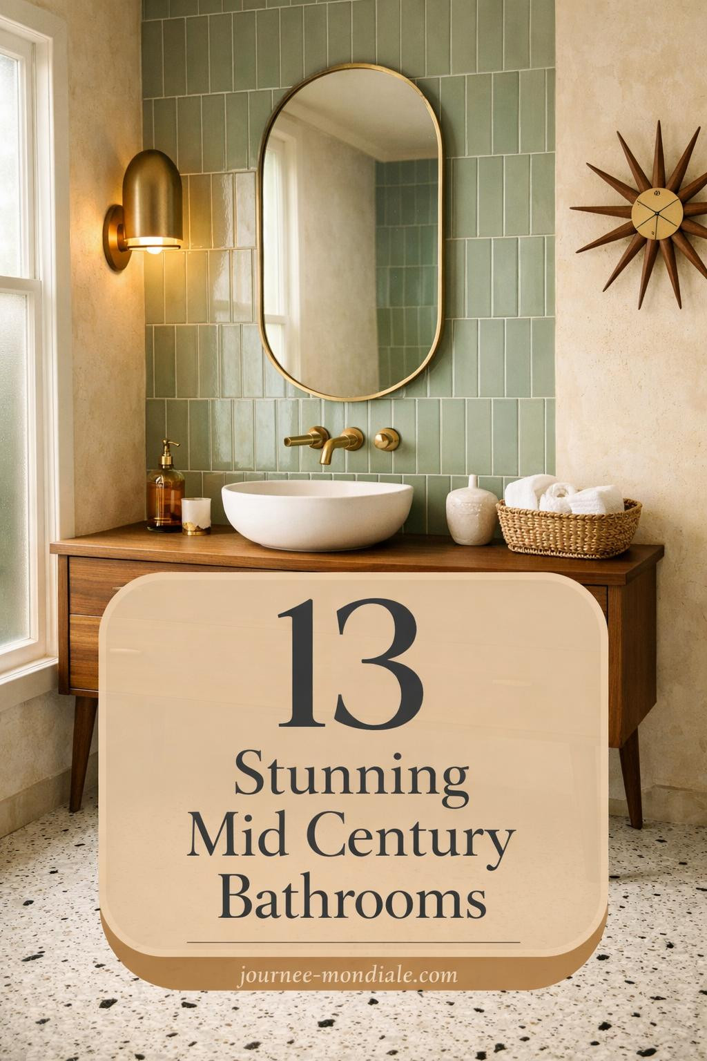 Sophisticated mid-century modern bathroom showcasing clean lines and organic warmth: walnut floating vanity with brass hardware, white terrazzo flooring, sage green geometric wall tiles, matte ceramic vessel sink, frameless oval mirror, and soft morning light through frosted window. Curated accessories include amber glass dispenser, rolled towels, and teak starburst clock.