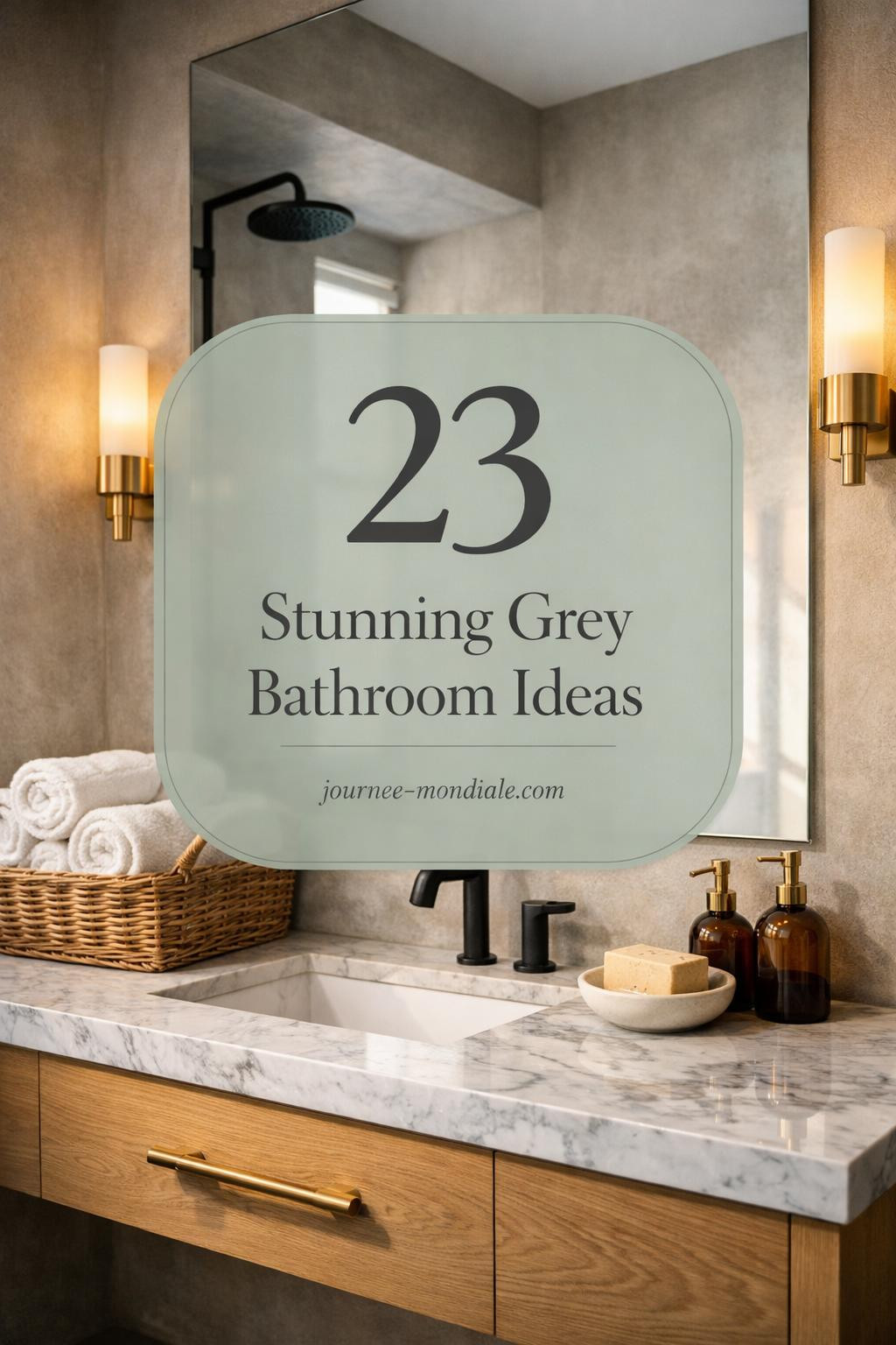 Sophisticated modern bathroom in refined grey palette with warm greige plaster walls, honed Carrara marble vanity countertop, custom white oak floating vanity, unlacquered brass hardware, frameless mirror reflecting soft light, matte black rainfall showerhead, grey porcelain tiles, white Turkish towels, artisan soap, and brushed brass sconces.