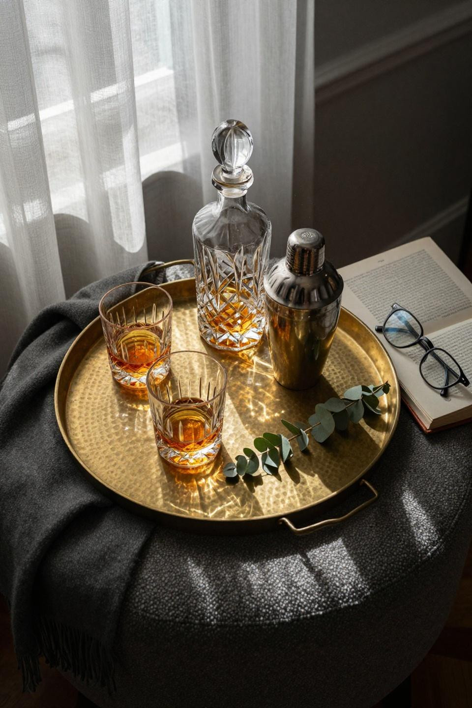 Bar Tray Styling - hand-hammered brass tray on charcoal boucle ottoman