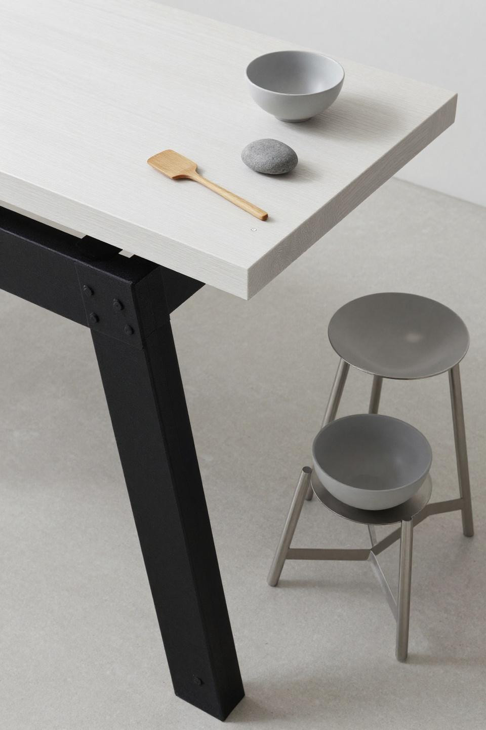 Wabi sabi kitchen - white oak counter cantilevering from exposed blackened steel I-beam