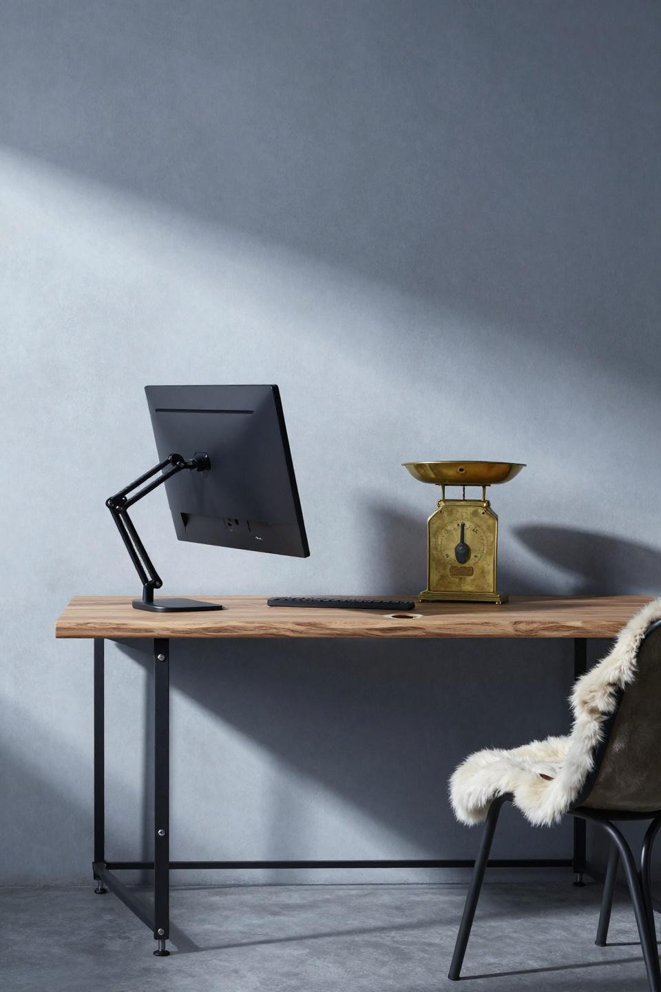 Minimalist desk decor - walnut desk cantilevered by steel cable system in concrete alcove