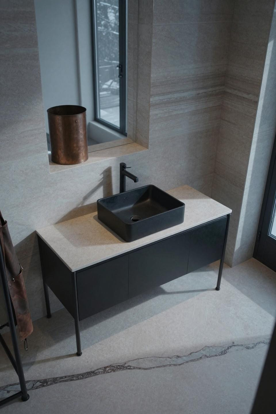 timeless bathroom - blackened steel floating console with matte black vessel sink on pale travertine countertop