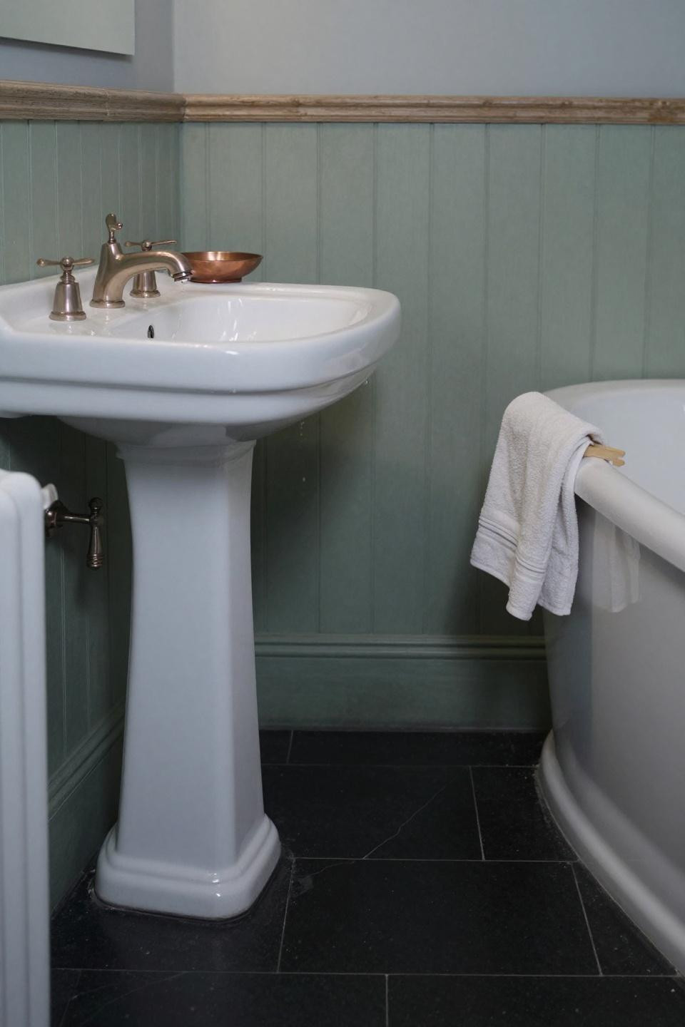 Victorian bathroom with sage green walls and pedestal sink