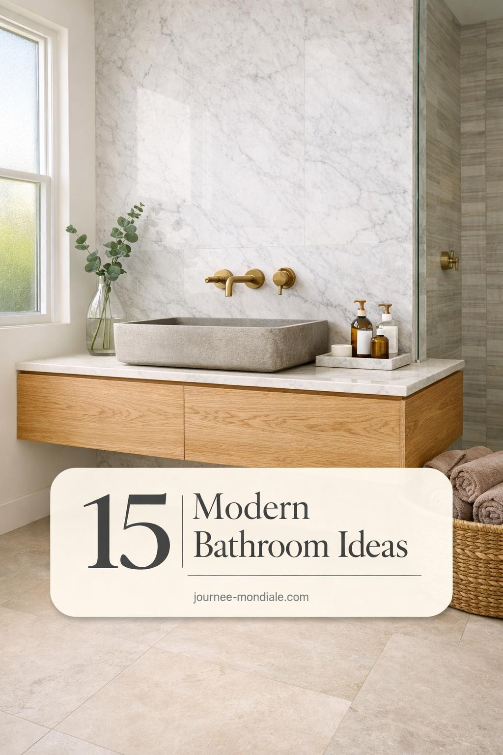 Sophisticated modern bathroom featuring floating white oak vanity, honed Carrara marble wall, brass fixtures, limestone floors