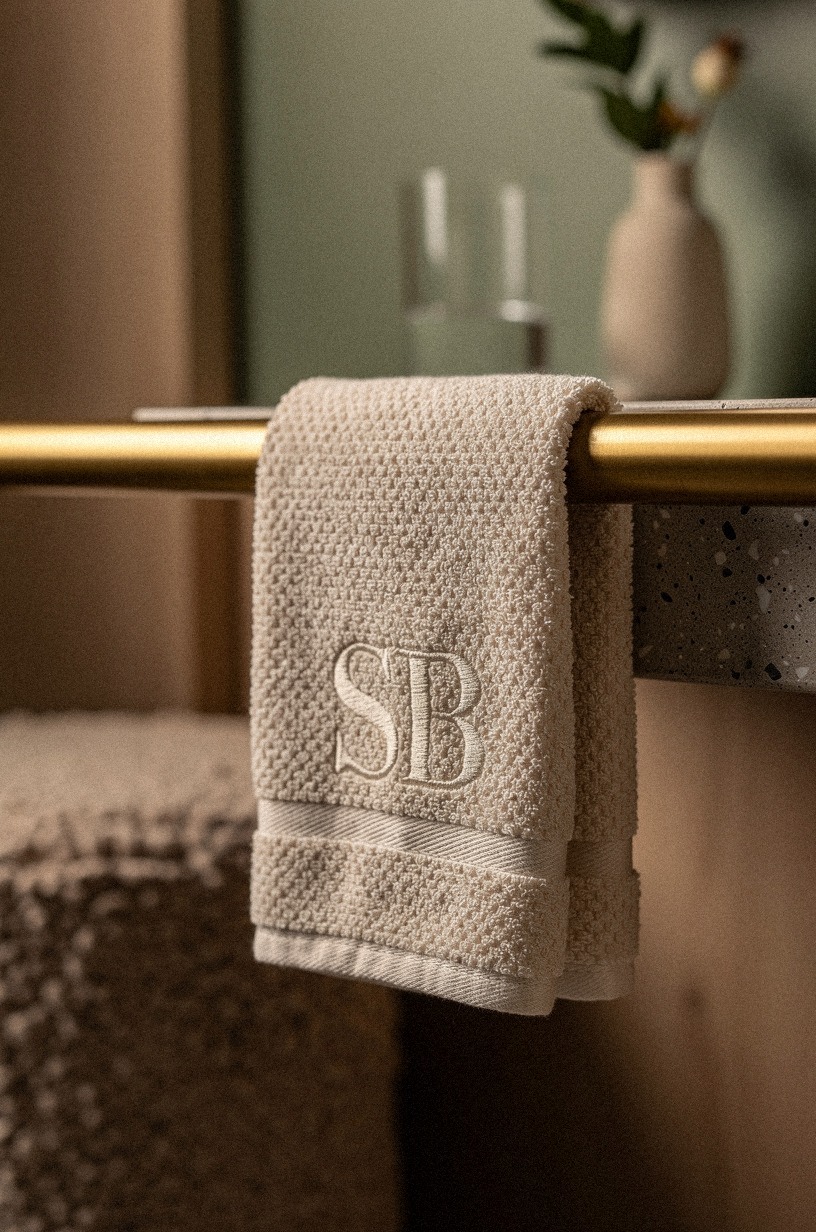 Style a brass rail with monogram towels