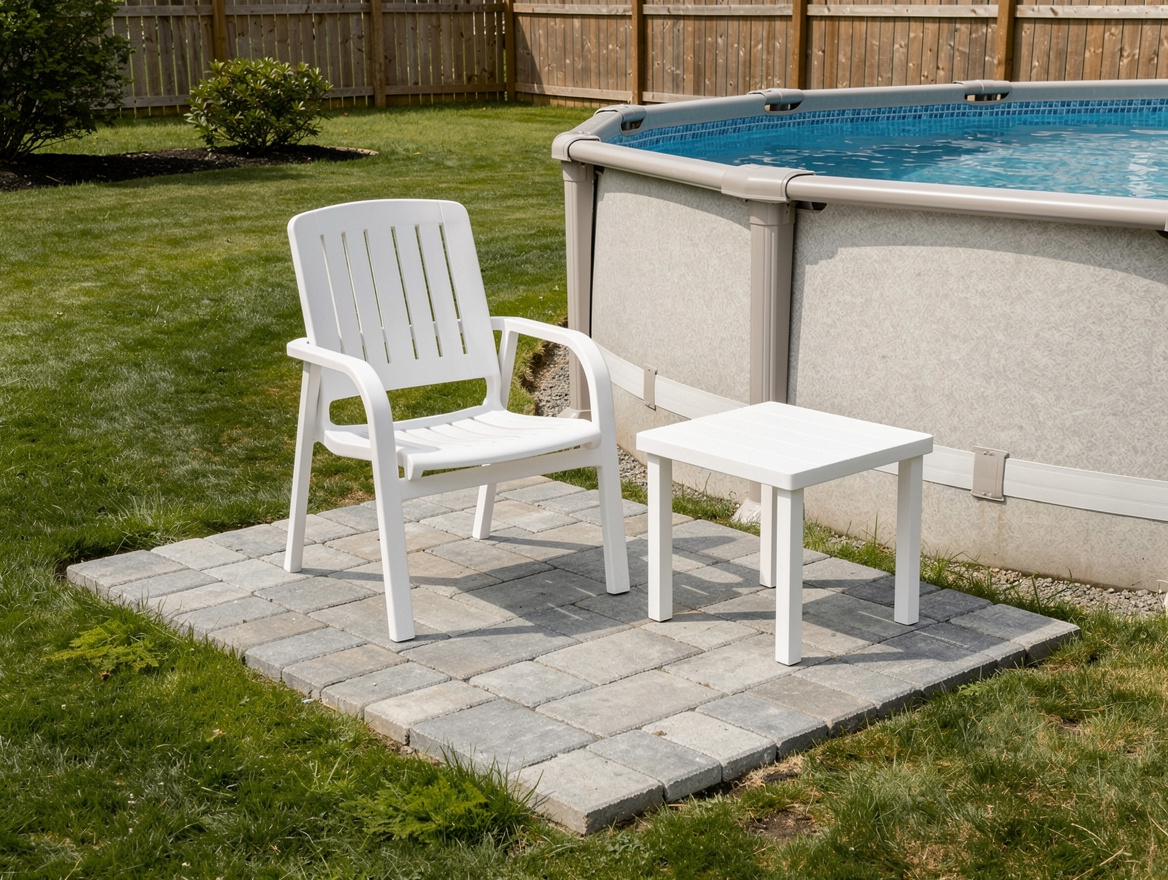 Medium shot of a small 3x4-foot paver landing pad next to an above-ground pool w