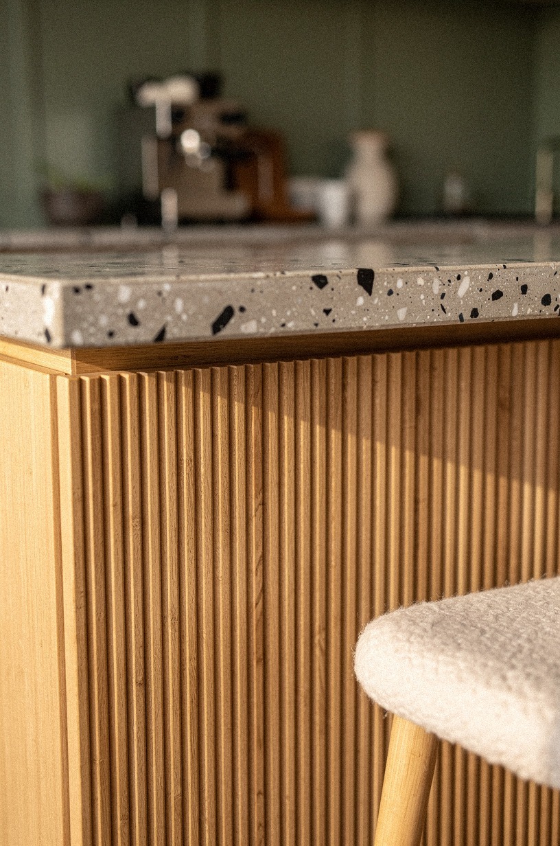 Add fluted wood panels around the island (The Velvet Booth Effect)