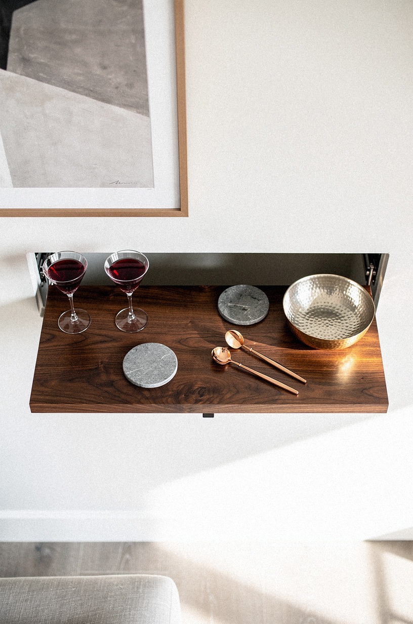 Mount framed art over a drop-down shelf