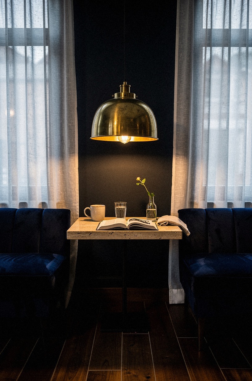 Hang a Single Oversized Brass Pendant Low Enough to Read By