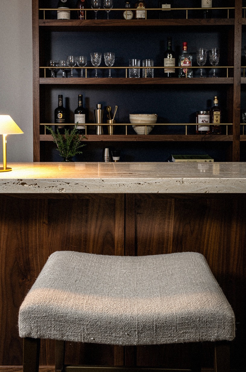 Add brass rails across the lower shelves