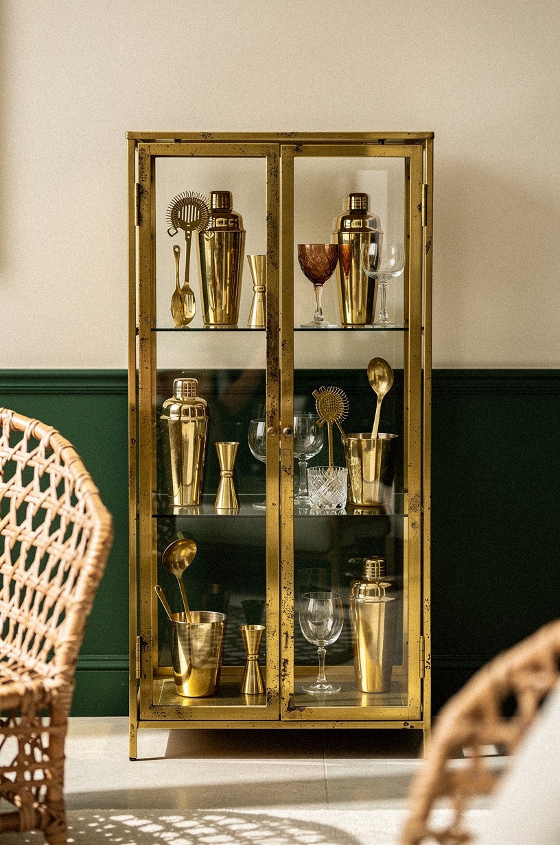 Style gold barware inside a cabinet