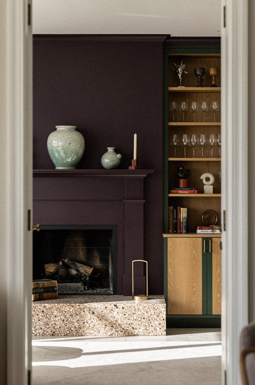 Frame the fireplace in deep aubergine