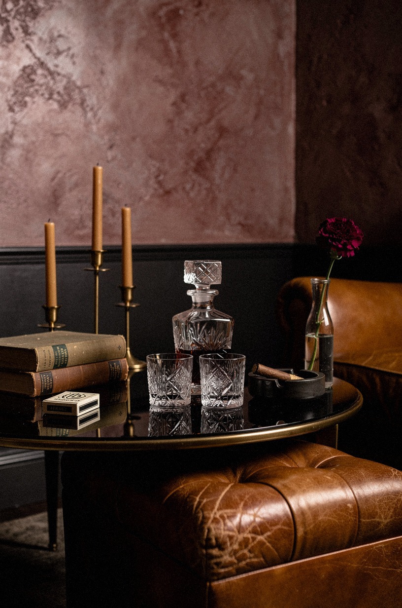 The coffee-table confession: crystal decanters on black lacquer