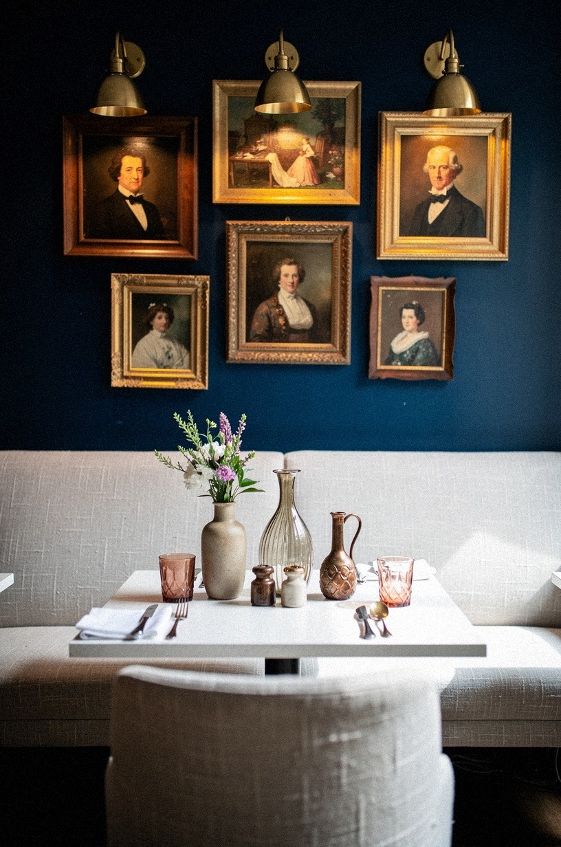 Cluster brass picture lights over vintage portraits