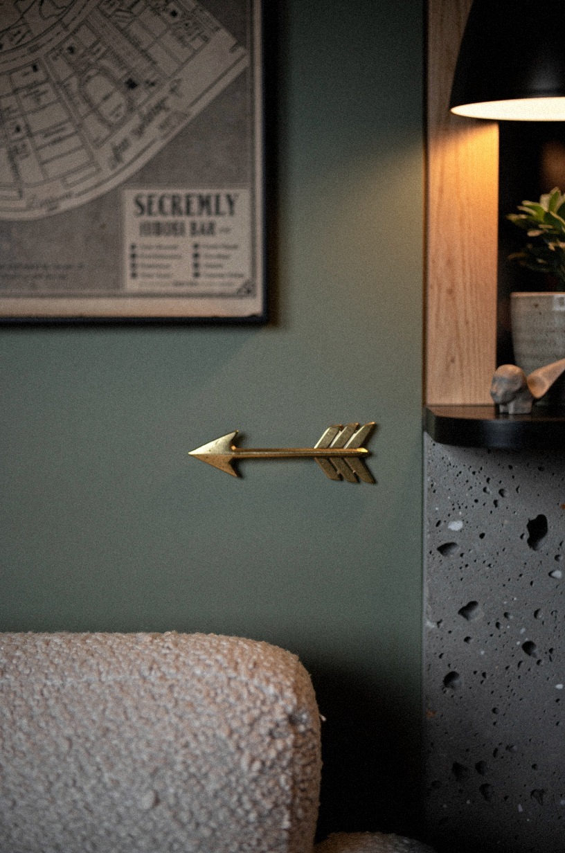 Add brass arrows toward the hidden bar