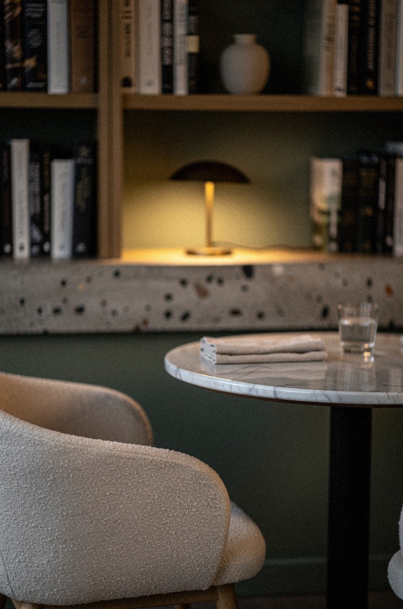 Set a marble bistro table near bookshelves