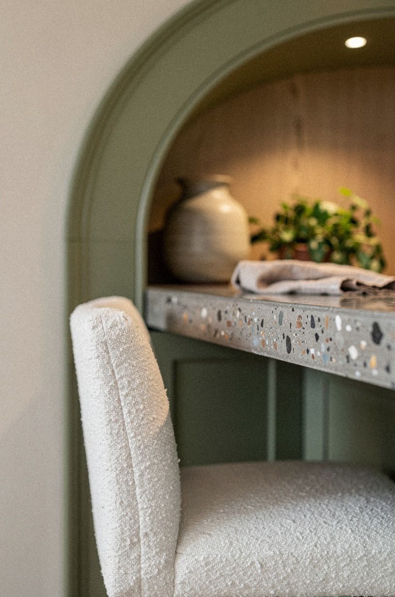 Frame a concealed bar with arched millwork