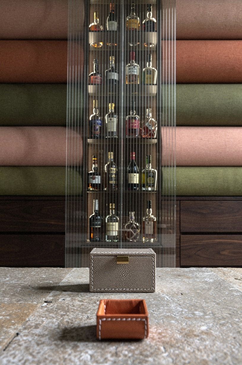 Slide ribbed glass panels across the bottles
