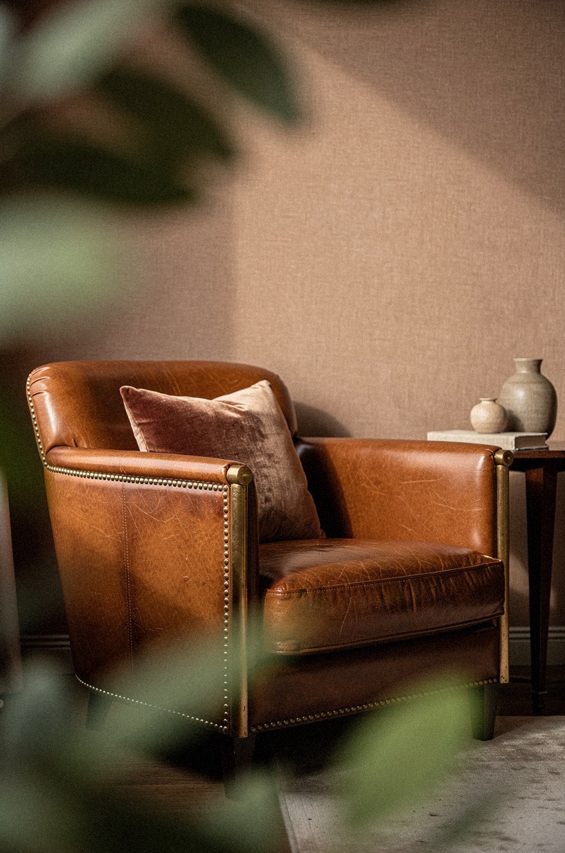 Add brass nailheads to leather club chairs