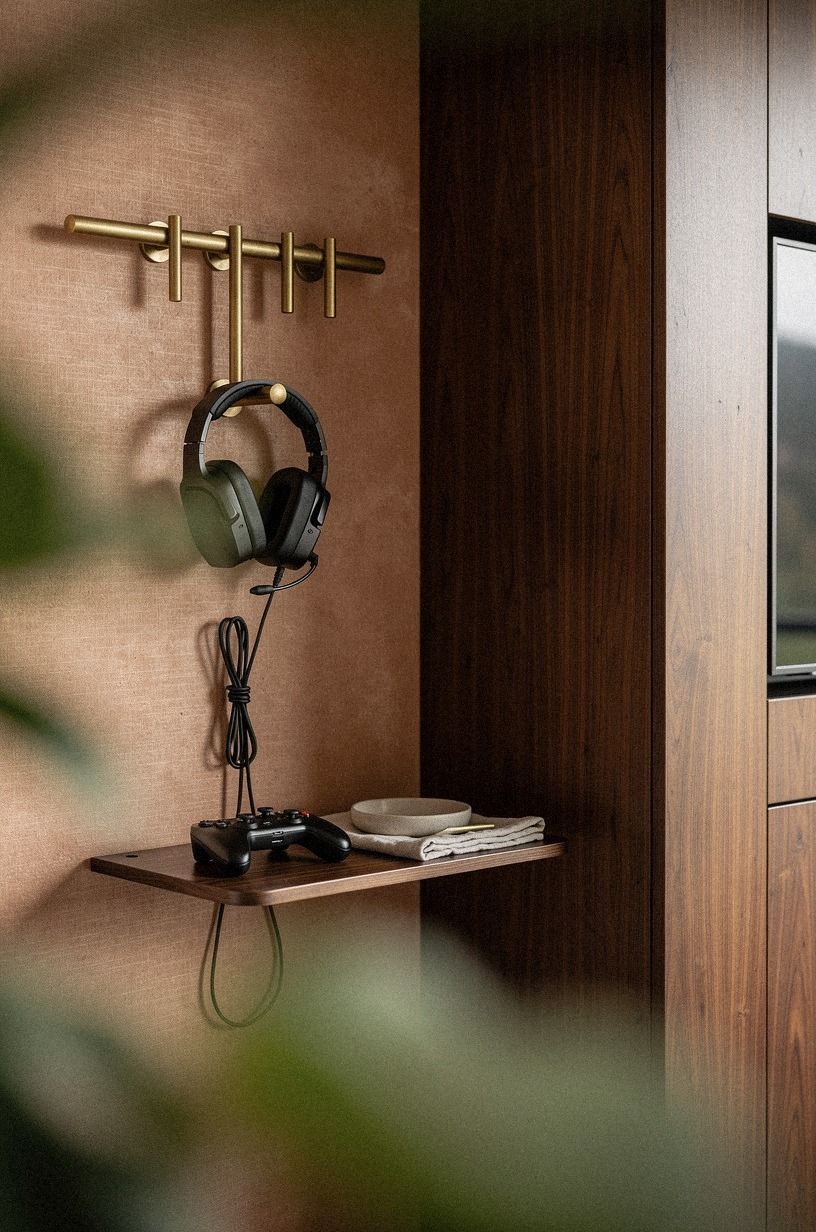 Disguise the headset hooks as brass pegs