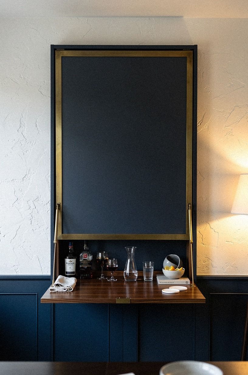 Build a fold-down shelf under framed artwork