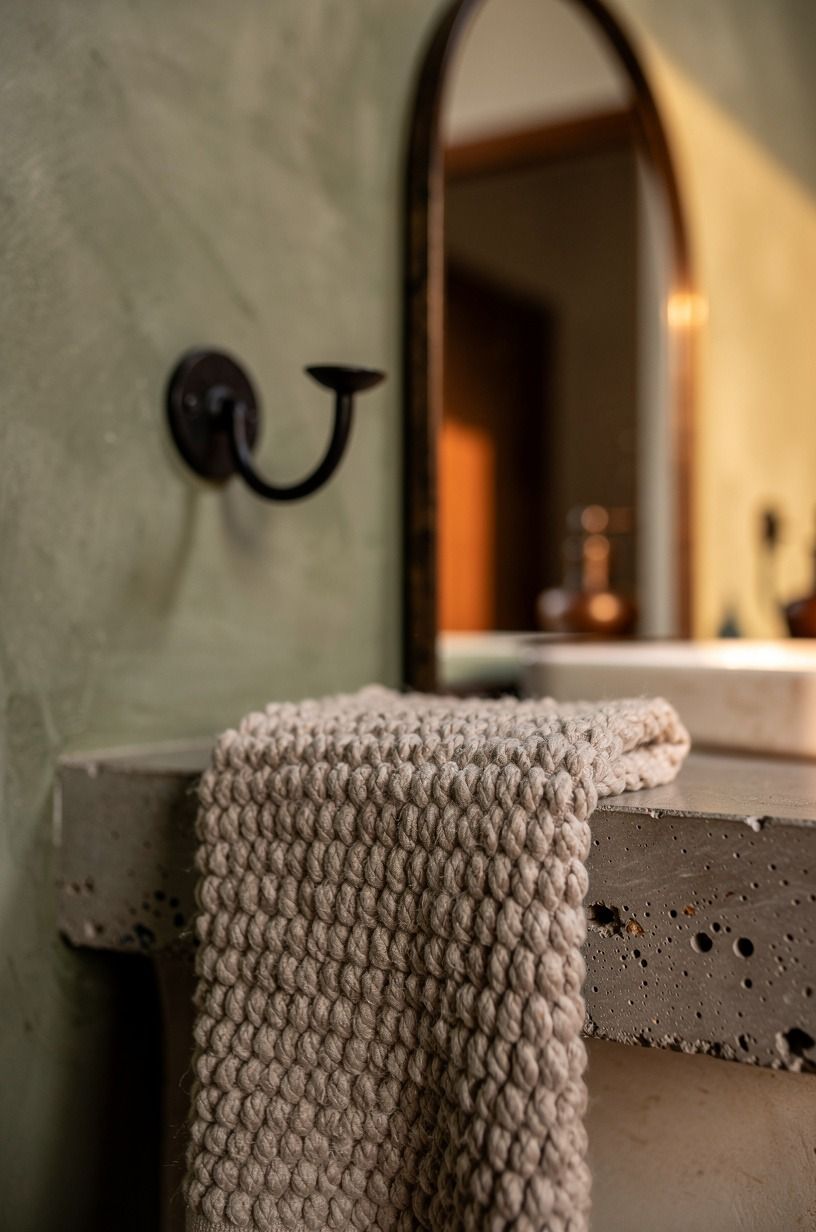 Add wrought-iron sconces beside the mirror