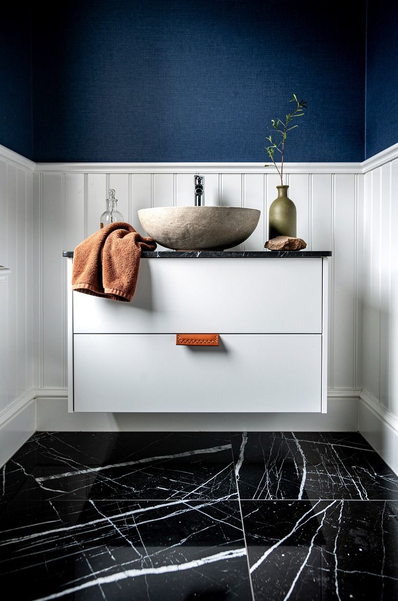 Layer indigo wallpaper above white wainscoting
