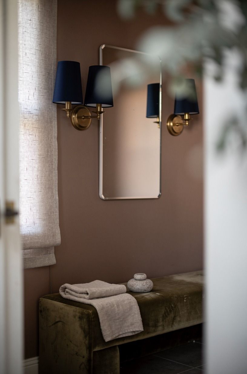 Install navy sconces with milk glass shades