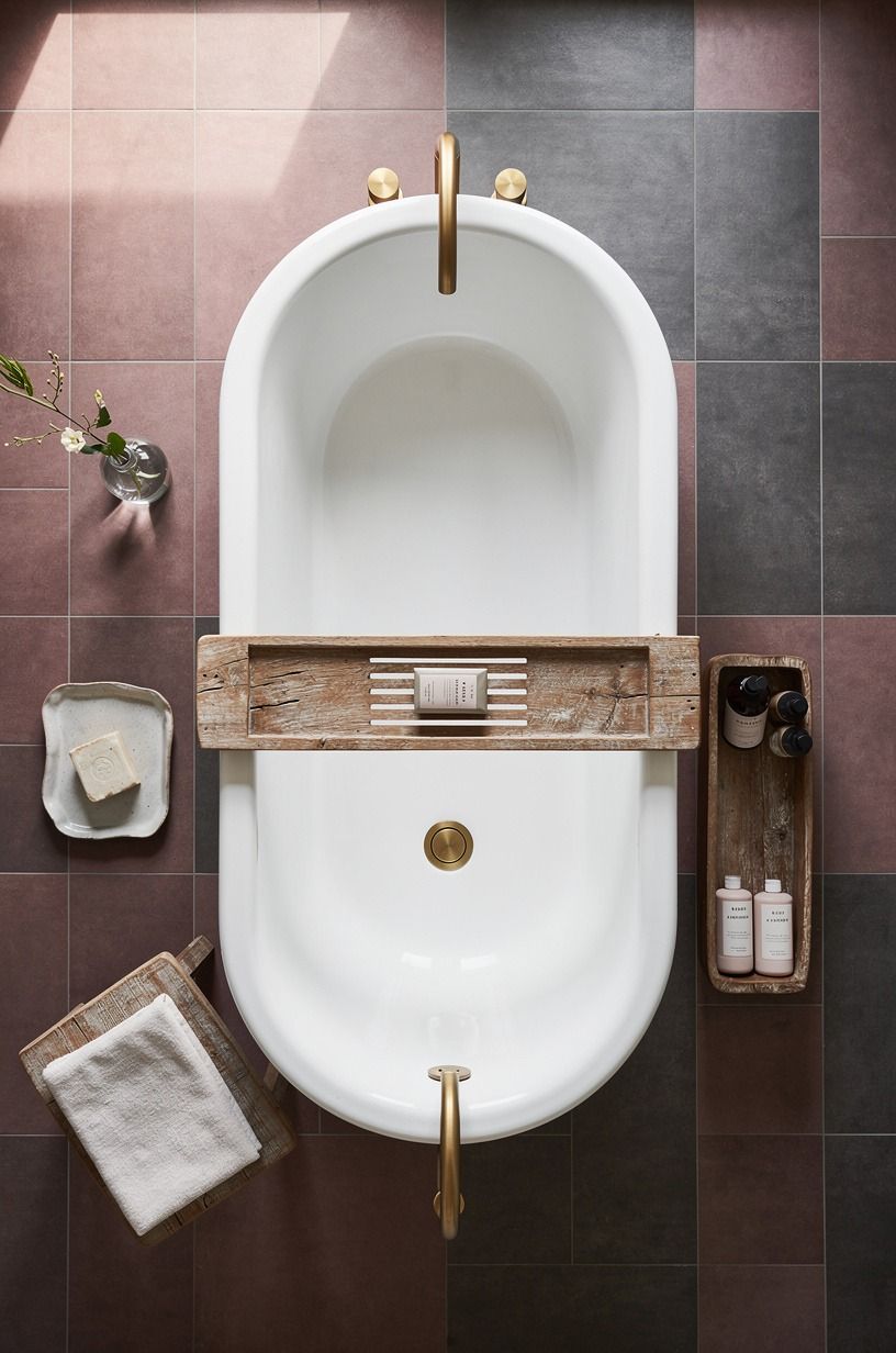 Anchor the tub with a quiet tile backdrop