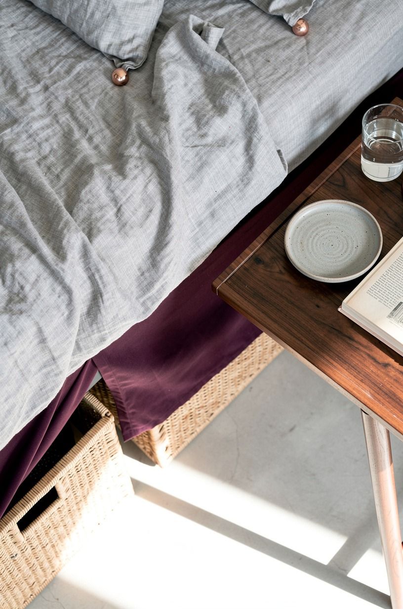 Slide baskets beneath a skirted bed