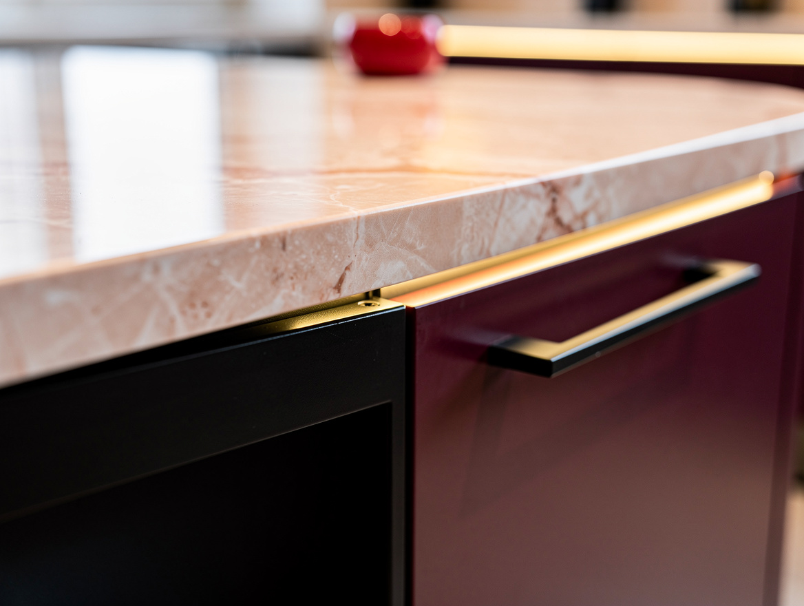 Close-up detail shot of a kitchen island corner showing quartz countertop edge,