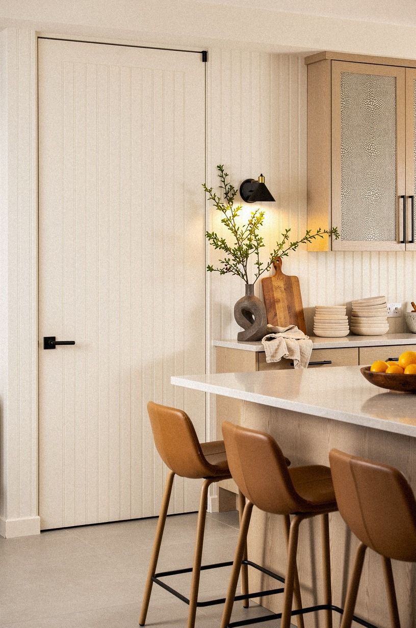 Camouflage the pantry with painted beadboard