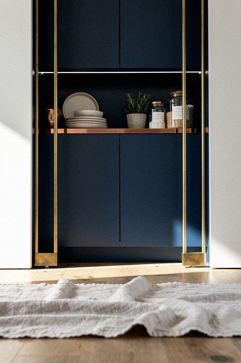 Frame the reveal with slim brass rails