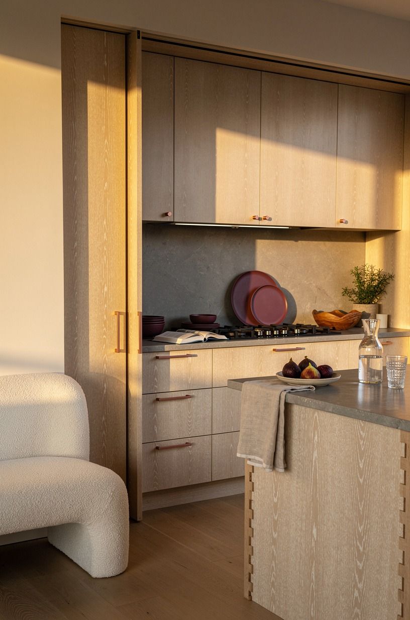 Why not pocket the doors completely? Run pocket doors across the entrance in matching oak