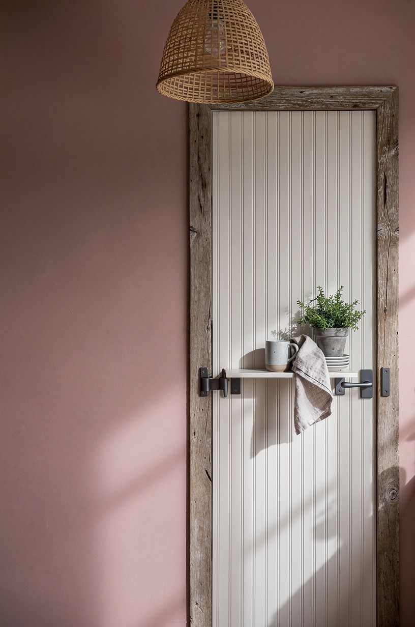 Line the hidden door with beadboard for a cottage disguise