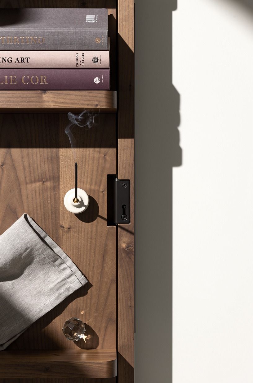 Hide the latch behind stacked art books