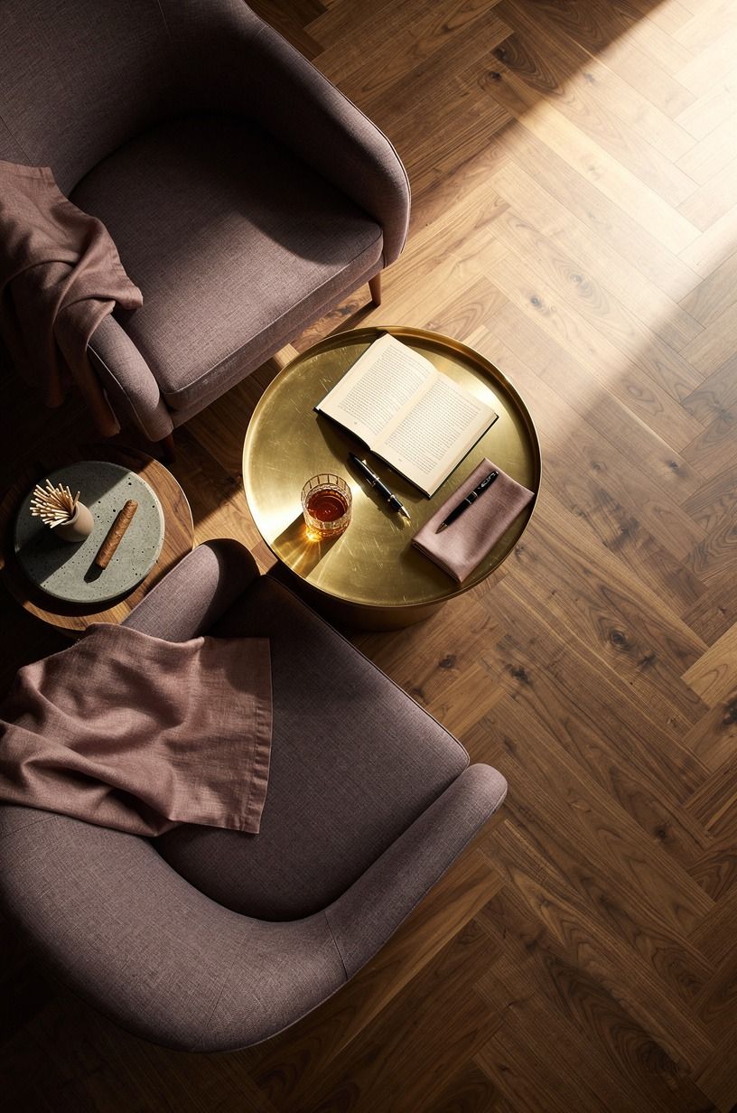 Layer club chairs around a brass cocktail table