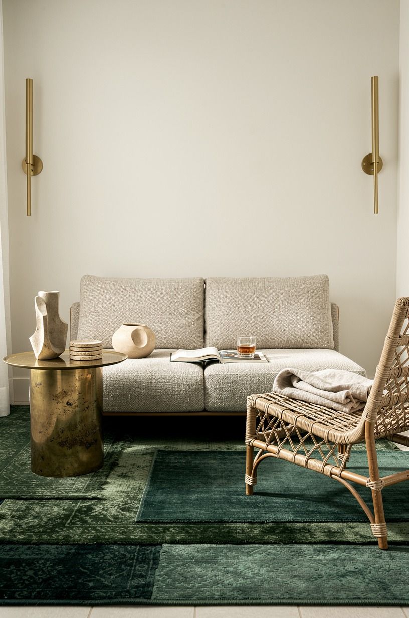 Layer moody rugs under low seating