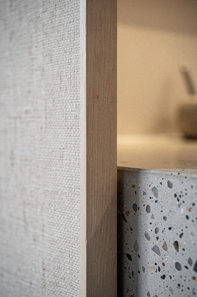 wrap the panel in grasscloth to blur the edge