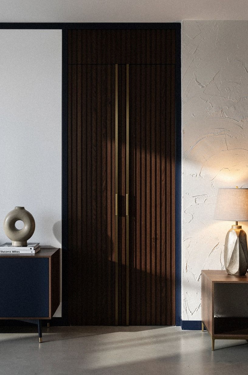Inset brass pulls between darker timber strips