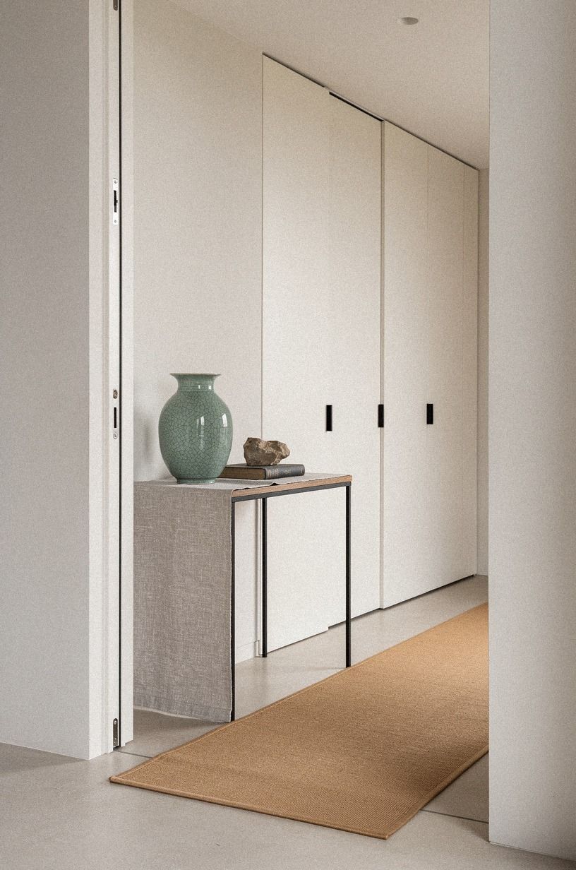 Add a floor runner toward the concealed door