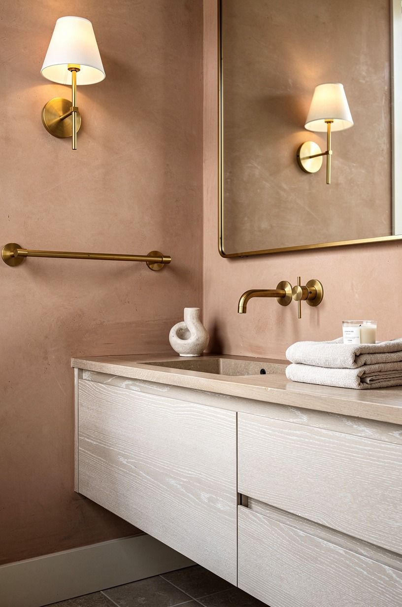Choose brass over chrome for a warm bathroom wall