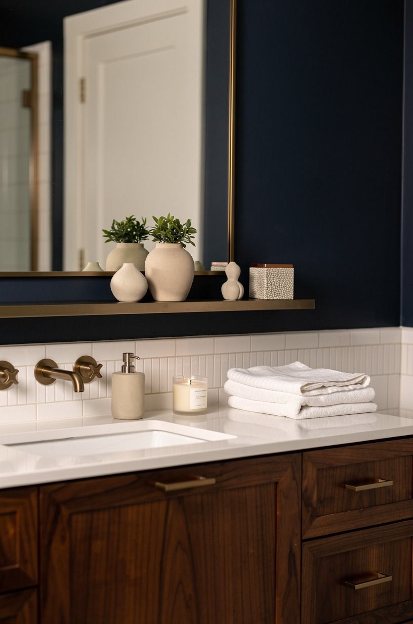 Float a slim shelf below the mirror