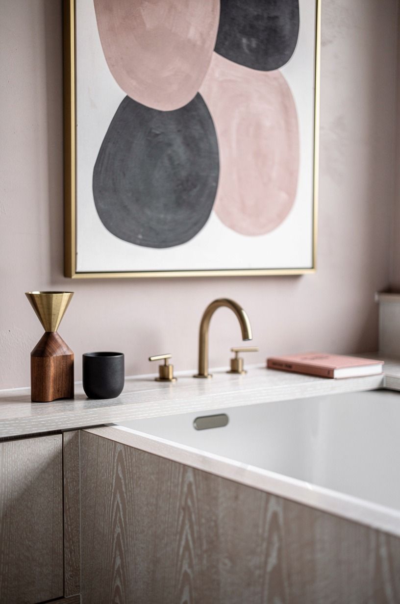 Frame the tub with a ledge and one oversized art piece