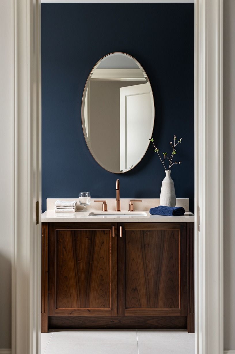 Hang an oval mirror above a blue wall