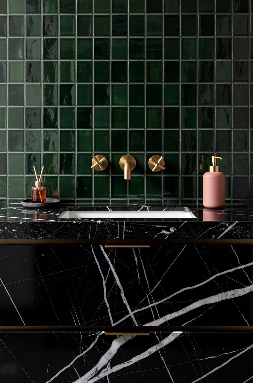 Layer dark green zellige behind a black vanity