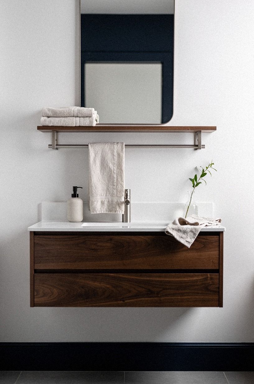 Hang a slim rail under the floating shelf