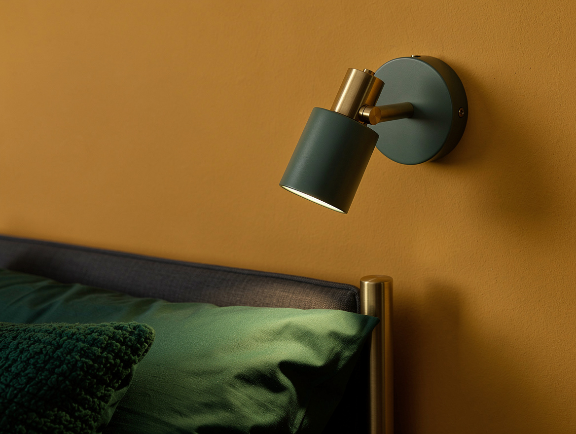 Realistic close-up editorial photo of a compact Muuto Tip style wall sconce besi