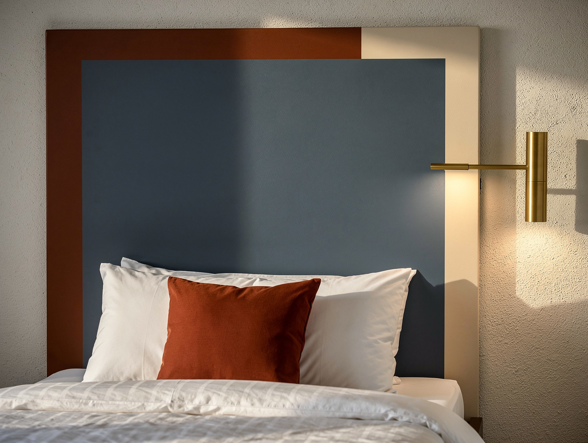 Realistic close-up editorial photo of a painted headboard block behind a compact