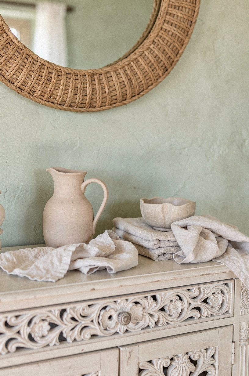 Hang a woven mirror above carved wood